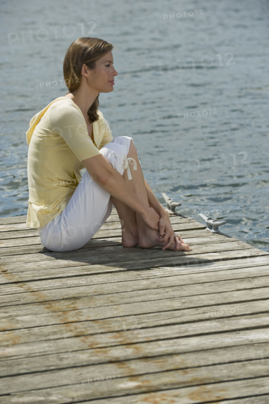 Woman sitting on dock.