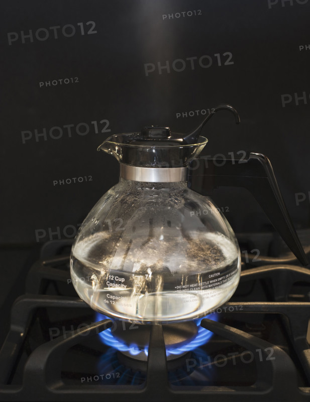 Close up of water boiling on stove.
