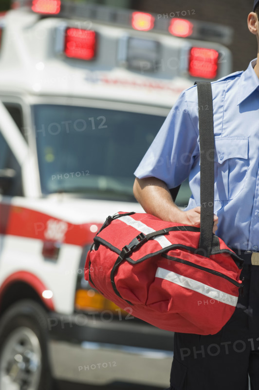 EMT carrying medical kit.