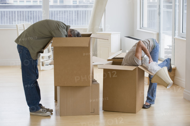 Couple unpacking moving boxes.