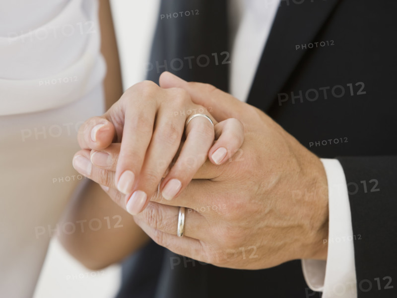Married couple holding hands.