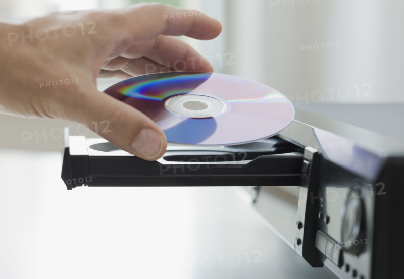 Man inserting dvd.