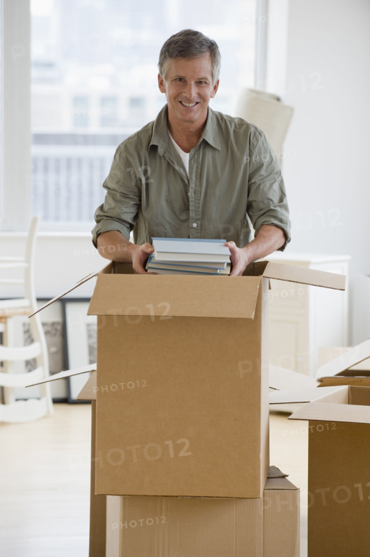 Man unpacking moving boxes.