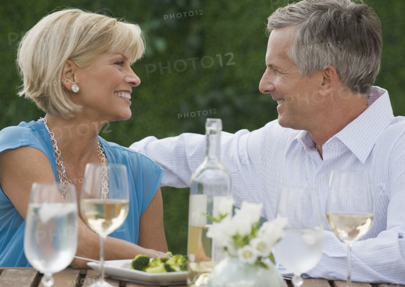 Couple enjoying wine outdoors.