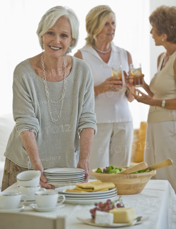 Senior women socializing at luncheon.