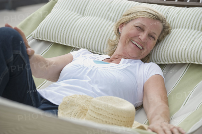 Woman relaxing in hammock.