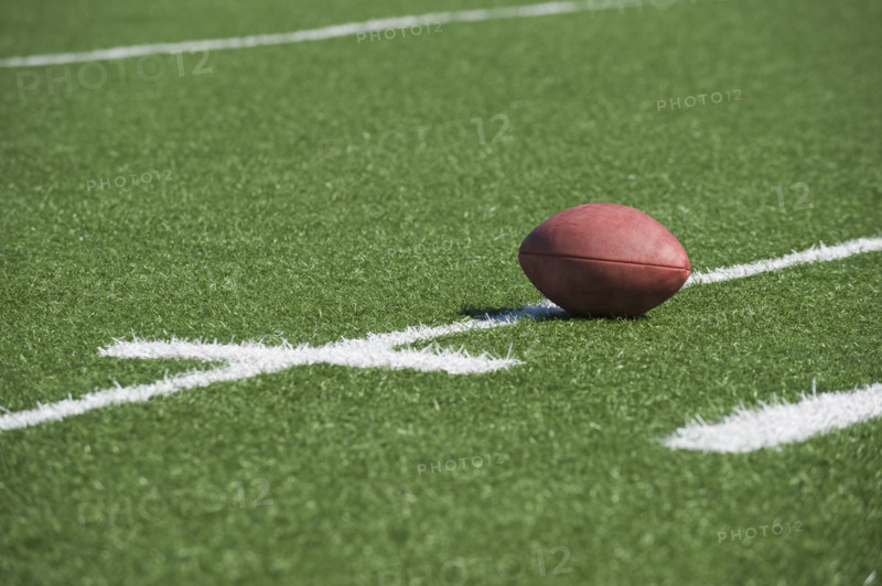 Football on yard line marker.