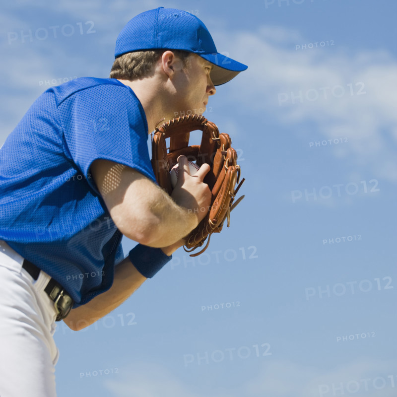 Baseball pitcher preparing to pitch ball.