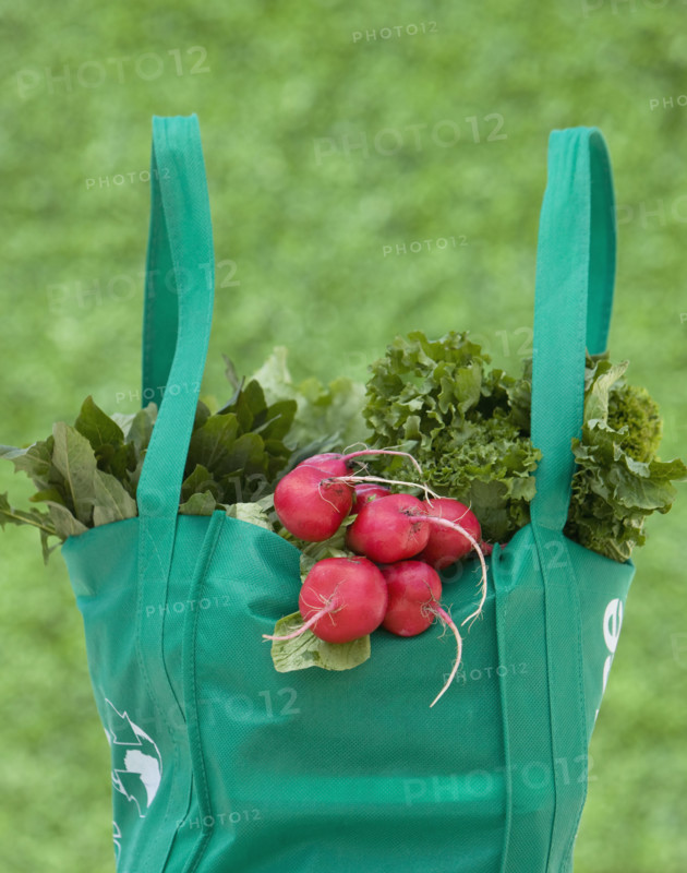 Organic produce in reusable grocery bag.