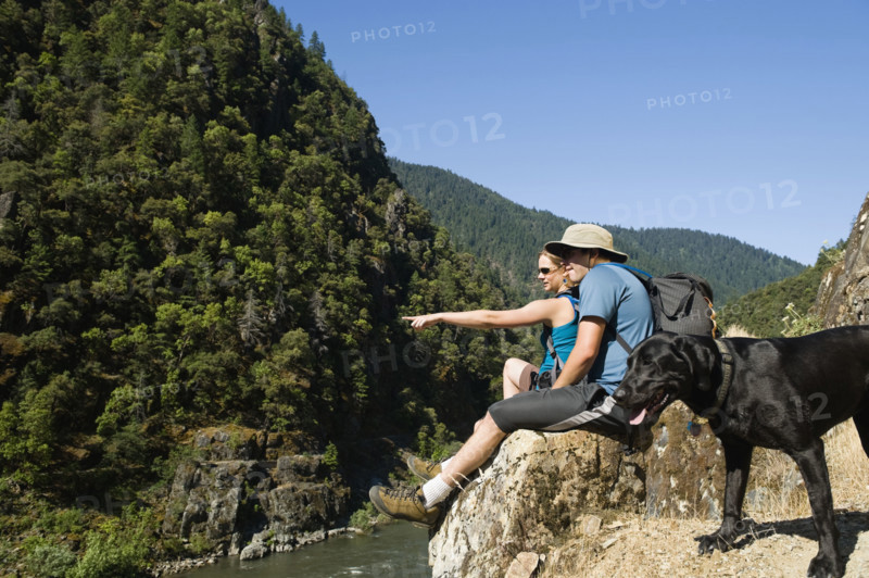 Hikers relaxing on river overlook. Date : 2008