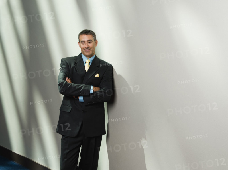 Businessman leaning against wall. Date : 2008