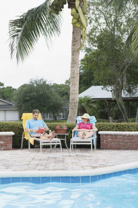 Couple relaxing poolside. Date : 2008