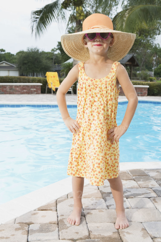 Sassy girl standing at edge of swimming pool. Date : 2008