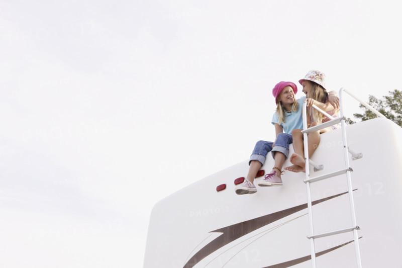 Girls sitting on top of motor home. Date : 2008