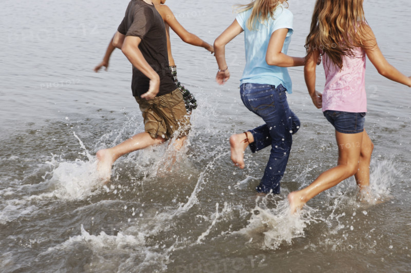 Children running in ocean. Date : 2008