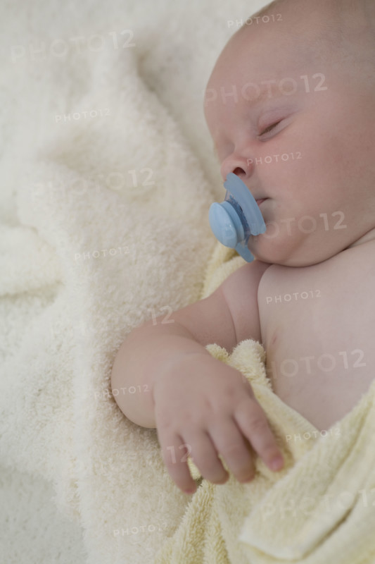Baby sleeping with pacifier in mouth. Date : 2008