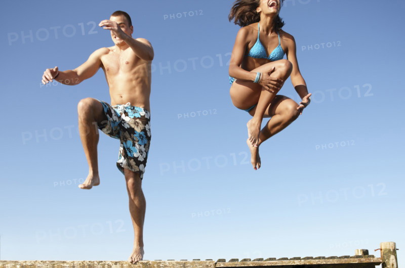 Young couple jumping of dock. Date : 2008
