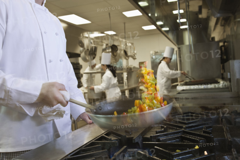 Chef tossing food in skillet. Date : 2008