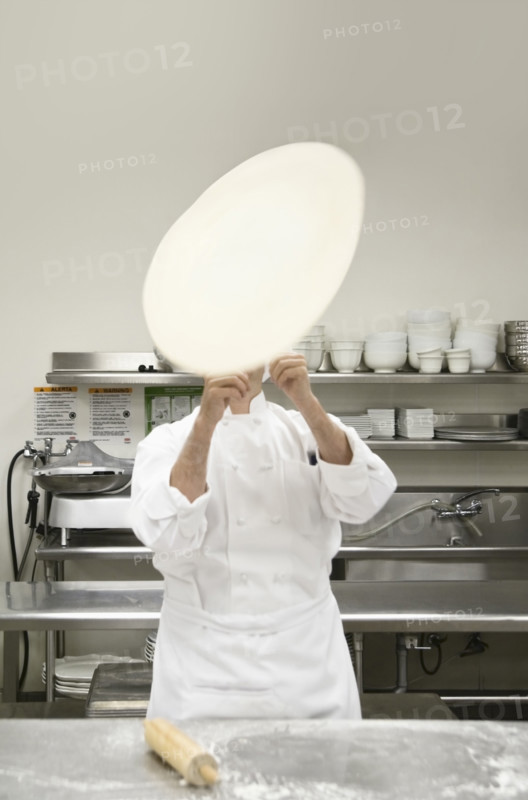 Chef tossing pizza dough. Date : 2008