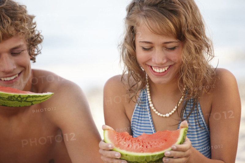 Young couple eating watermelon on beach. Date : 2008