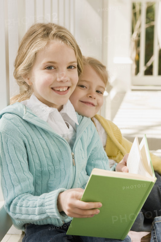 Sisters reading on porch. Date : 2008