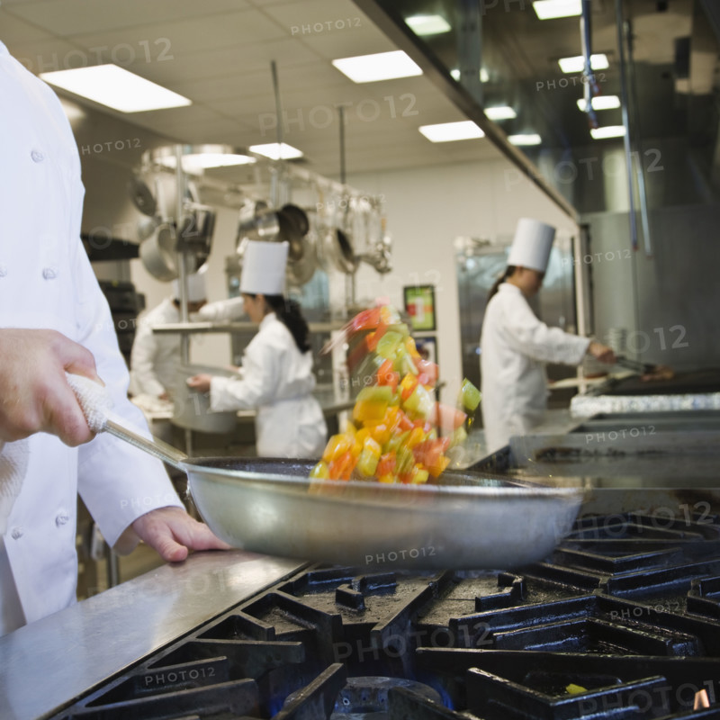 Chef tossing food in skillet. Date : 2008