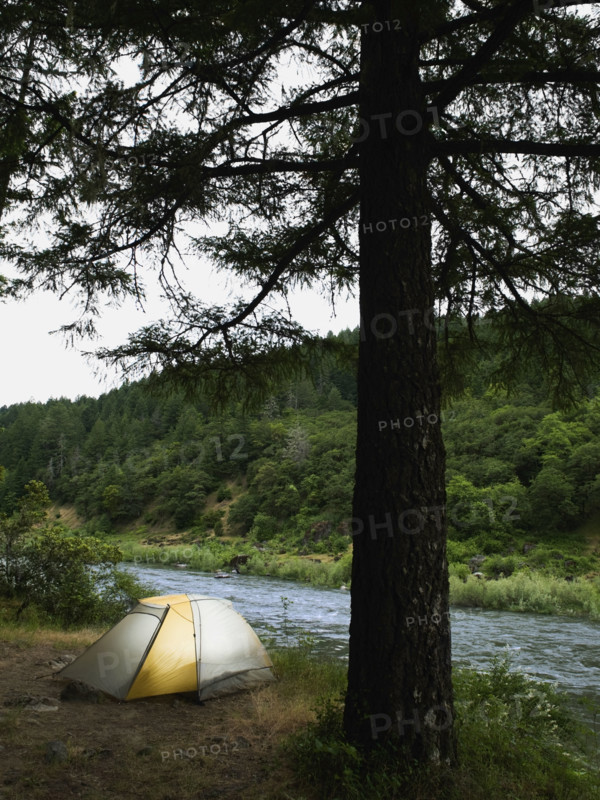 Tent and campsite by river. Date : 2008