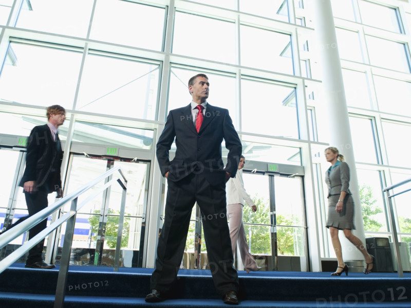 Confident businessman posing in lobby. Date : 2008