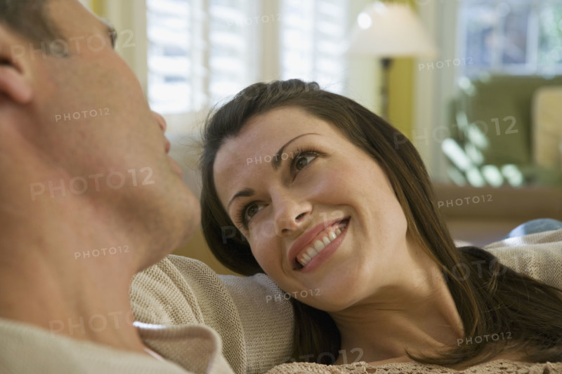 Couple relaxing in livingroom. Date : 2008