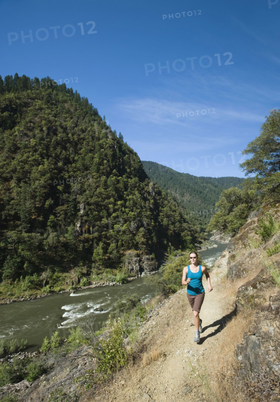Woman running on riverside trail. Date : 2008