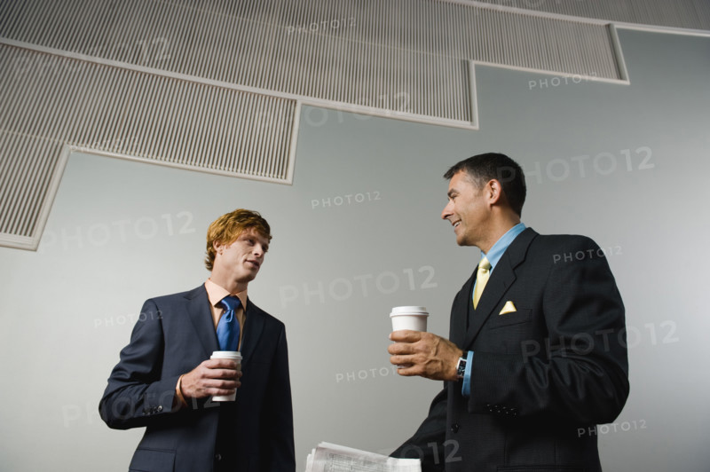 Businessmen talking during coffee break. Date : 2008