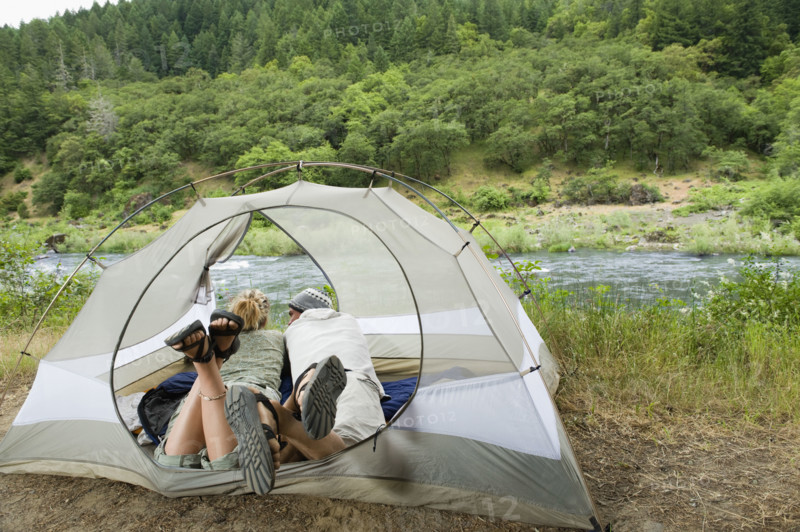 Couple relaxing in tent. Date : 2008