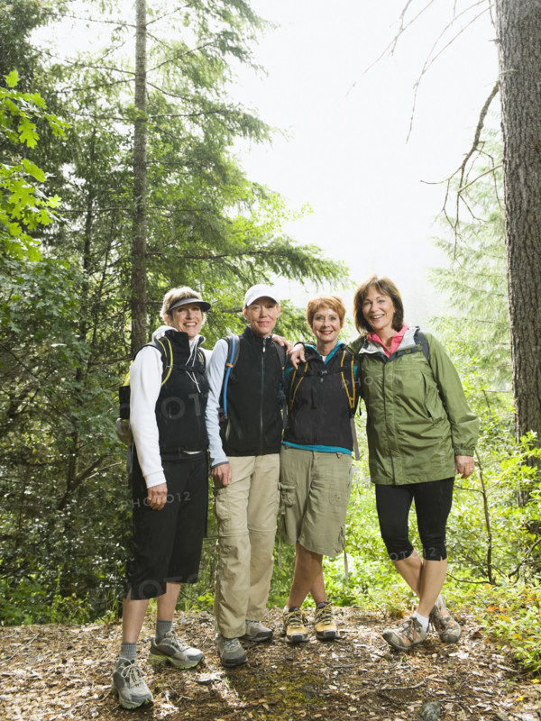 Female hikers posing in forest. Date : 2008