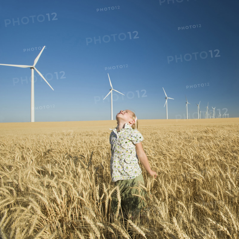 Girl looking to sky on wind farm. Date : 2008
