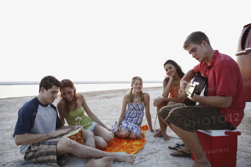 Friends socializing on beach. Date : 2008