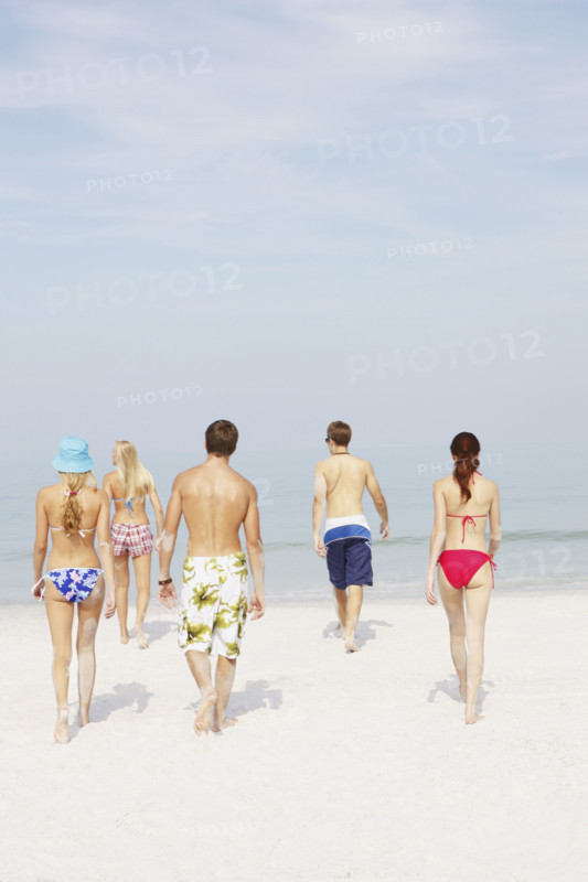 Friends walking on beach. Date : 2008
