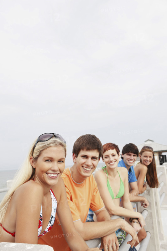 Friends posing on boardwalk railing. Date : 2008