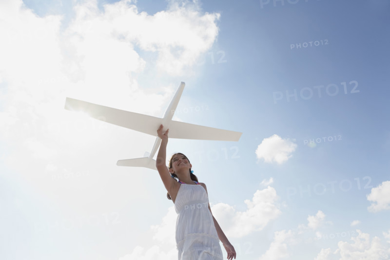 Girl flying model airplane. Date : 2008