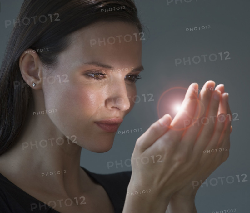 Light shining from woman’s hands.