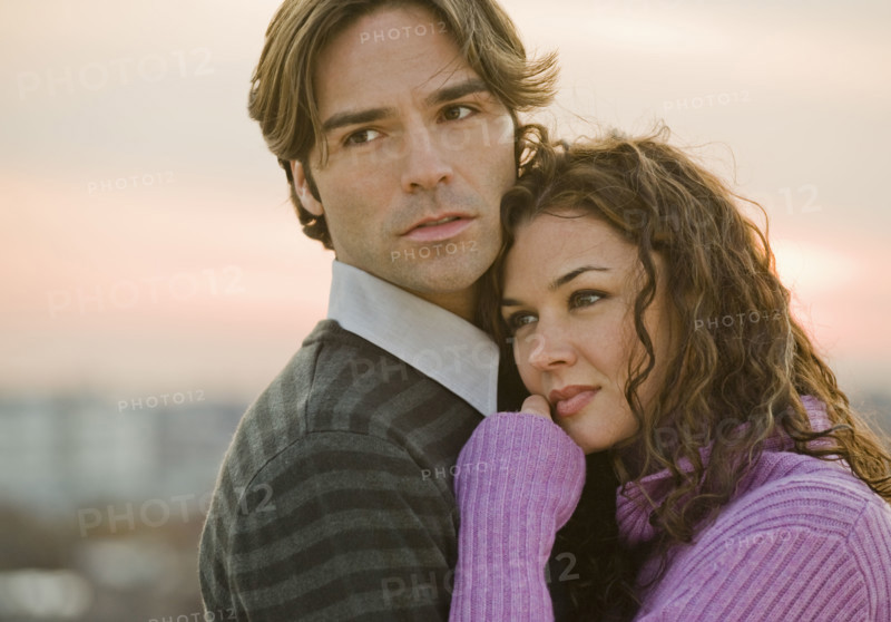Portrait of couple hugging.