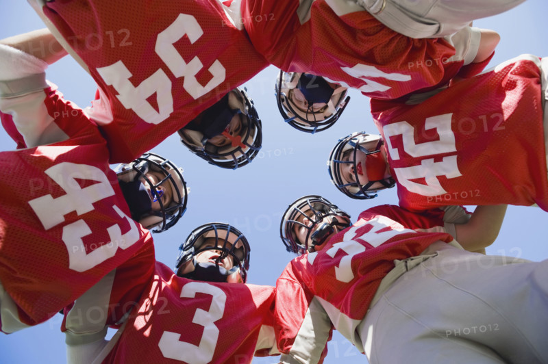 Football players in huddle. Date: 2008