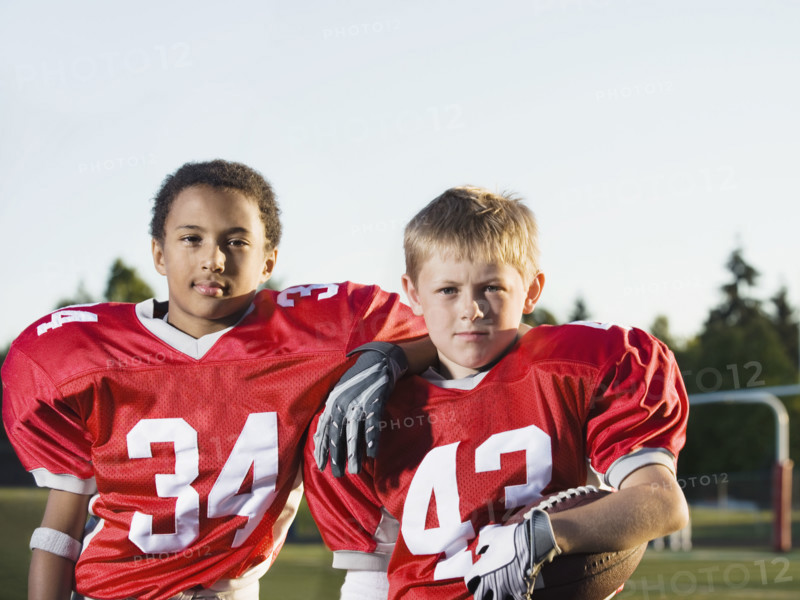 Football players posing on field. Date: 2008
