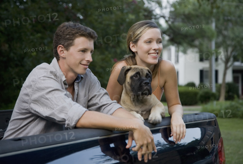 Couple and dog in back of truck. Date: 2008