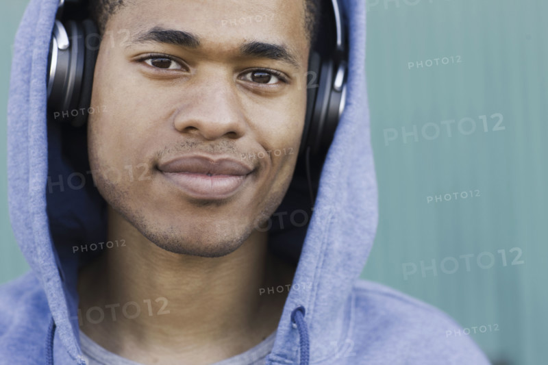 Close up portrait of young man listening to headphones. Date: 2008