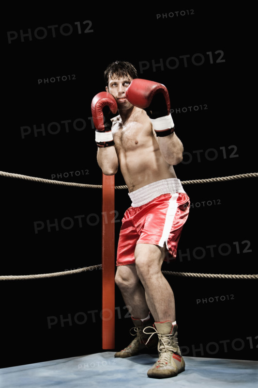 Boxer standing in fighting stance in boxing ring. Date: 2008