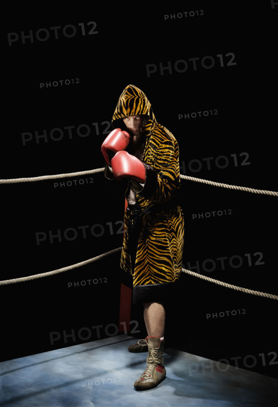 Boxer posing in fighting stance in boxing ring. Date: 2008