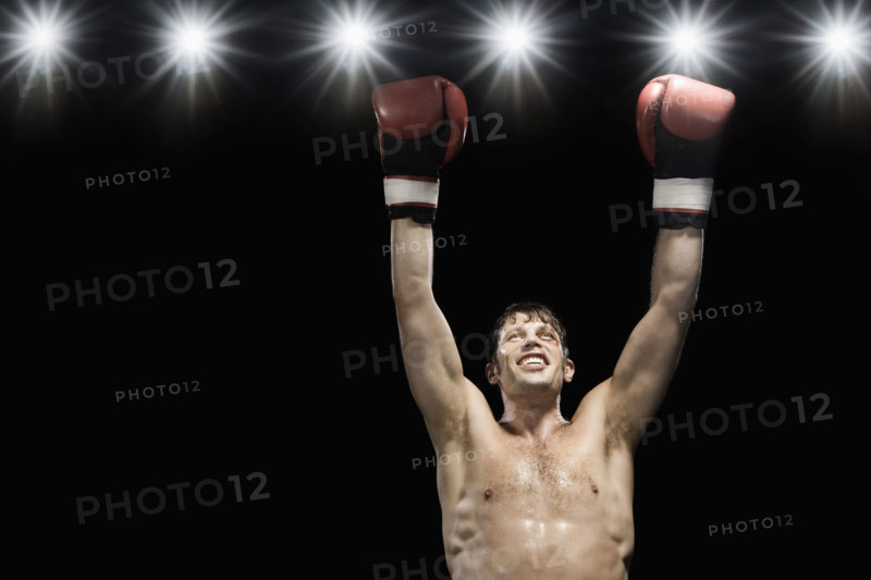 Boxer smiling with boxing gloves raised. Date: 2008