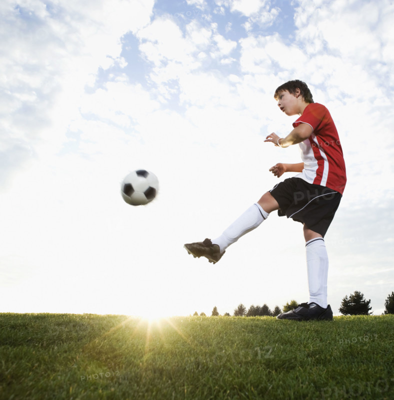 Boy in uniform kicking soccer ball. Date : 2008