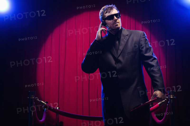 Bouncer listening to headset. Date: 2008