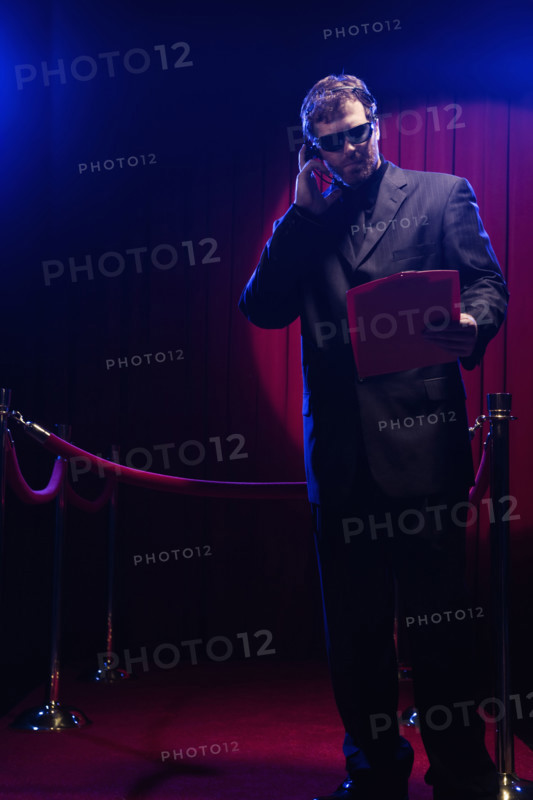 Bouncer looking at guest list. Date: 2008
